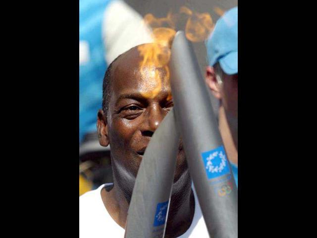 Former US Olympian Bob Beamon passes the Olympic flame during the torch relay in New York. Beamon set an Olympic and world record at the Mexico City games in 1968 with a long jump of 29 feet, two-and-a-half inches. His record stood for 23 years. Reuters/Todd Warshaw