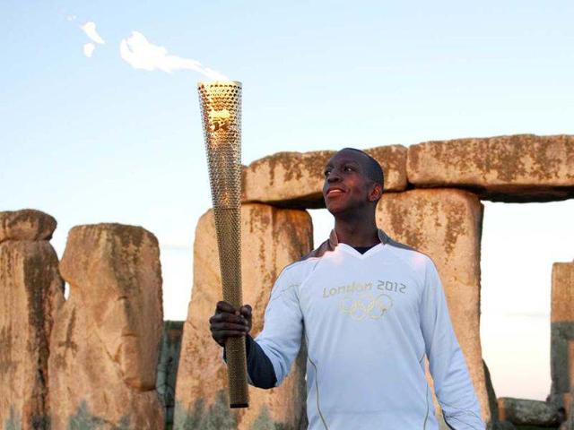 Former US Olympic athlete Michael Johnson holds the Olympic Torch at Stonehenge, a World Heritage site, in Salisbury, southern England. Come what may, Johnson will forever have Atlanta and those 10 days when he became the only male athlete ever to win both the 200 metres and 400 metres at the same Olympics. Reuters/Kieran Doherty