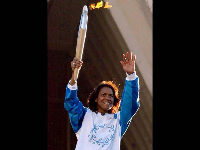 400 metres gold medallist Cathy Freeman holds the Olympic torch on the steps of the Sydney Opera House. Reuters photo