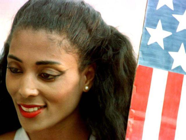 Florence Griffith Joyner poses next to an American flag at the 1988 Seoul Olympics. 'Flo Jo', who won three sprint gold medals at the Games, died of an apparent heart seizure. Gary Hershorn