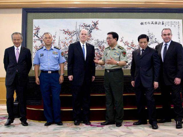 US national security advisor Tom Donilon talks with China central military commission vice chairman General Xu Caihou after a group photo session at the ministry of defense in Beijing, China. AP/Andy Wong