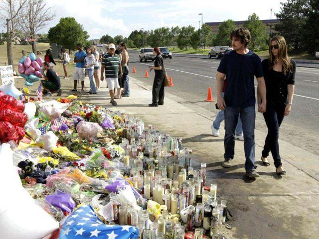 Actor Christian Bale and his wife Sandra Blazic leave the memorial across the street from the Century 16 movie theater July 24, 2012 in Aurora, Colorado. The memorial was created for the victims of the mass shooting that occured at the theater last Friday.