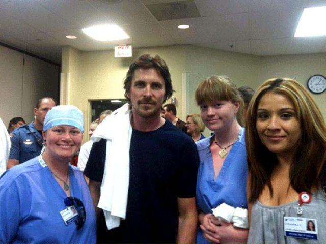 Actor Christian Bale, second left, poses with Swedish Medical Center staff at The Medical Center of Aurora, where several victims from the Friday shooting are admitted.