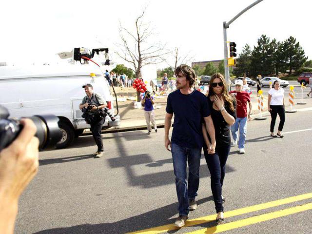 Actor Christian Bale and his wife Sibi Blazic arrive at a memorial for the victims of Friday's mass shooting, in Aurora. Twelve people were killed when a gunman opened fire during a late-night show of the movie The Dark Knight Rises.