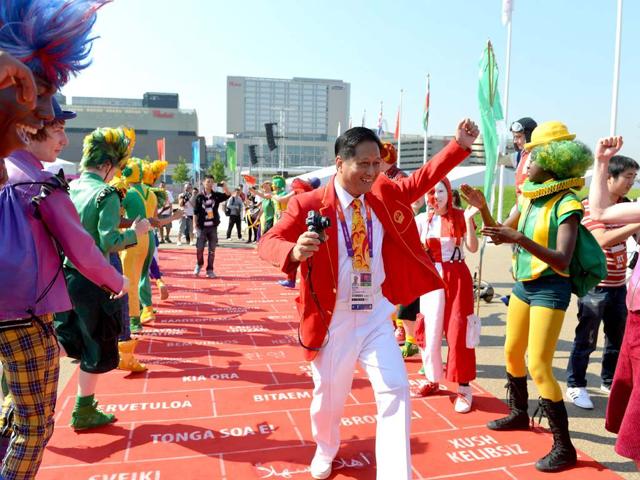 Doctor Chen Shiryi from China dances during an arrival ceremony for athletes at the Olympic Village in London, two days before the start of the London 2012 Olympic Games. AFP/Adek Berry