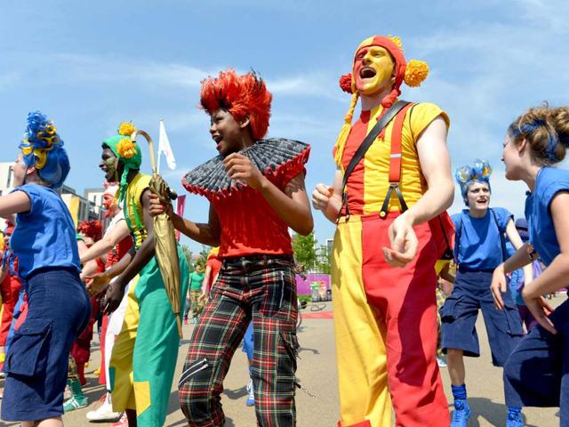 Dancers perform during an arrival ceremony for athletes at the Olympic Village in London, two days before the start of the London 2012 Olympic Games. AFP/Adek Berry