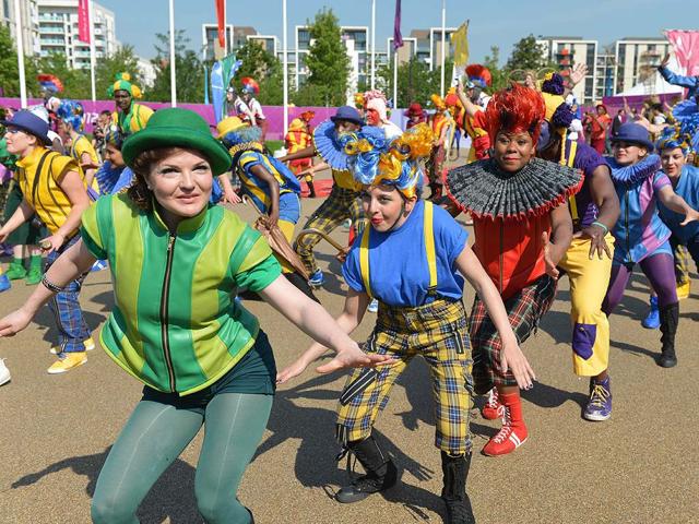 Dancers perform during an arrival ceremony for athletes at the Olympic Village in London, two days before the start of the London 2012 Olympic Games. AFP/Adek Berry