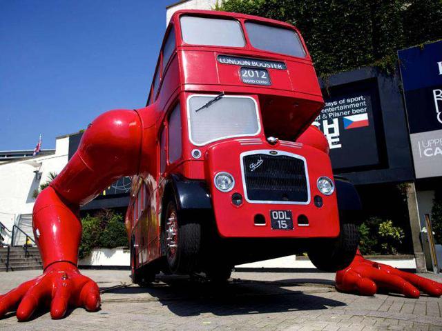 A picture shows David Cerny's double-decker bus art installation "London Booster". The Czech artist has adapted a 1957 London bus and added huge mechanical arms which enable it to do press-ups. (AFP photo/Andrew Cowie)