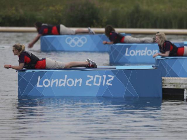 Volunteers lay down watching rowing training in Eton Dorney, near Windsor, England, at the 2012 Summer Olympics. (AP Photo/Armando Franca)