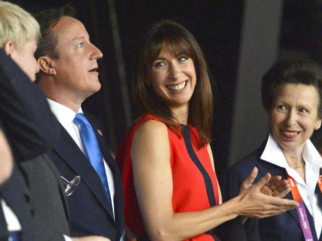 Britain's Prime Minister David Cameron, left, stands with his wife Samantha, center, and Princess Anne after arriving for the Opening Ceremony of the 2012 Olympic Summer Games at the Olympic Stadium in London. (AP Photo/Toby Melville, pool)