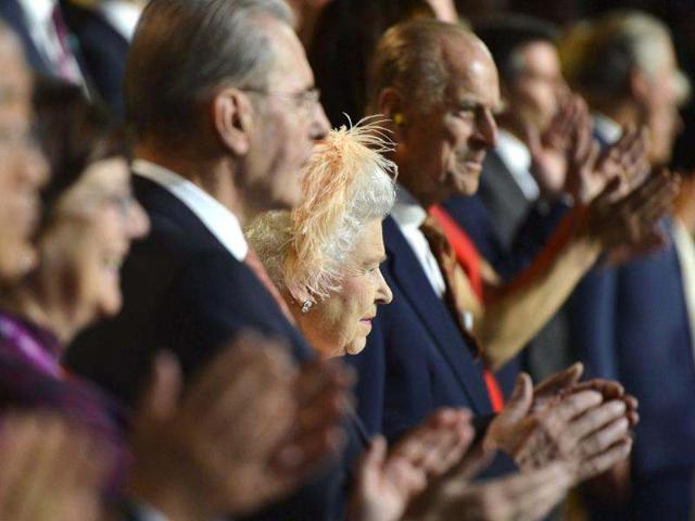 Britain's Queen Elizabeth II, center, is flanked by Britain's Prince Philip, the Duke of Edinburgh, and IOC President Jacques Rogge, left, as she attends the Opening Ceremony of the 2012 Olympic Summer Games at the Olympic Stadium in London. (AP Photo/Toby Melville, Pool)