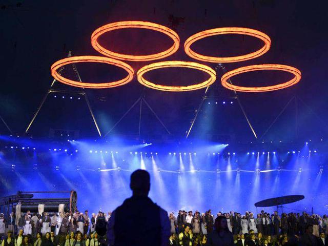 Photo shows the Olympic rings floating above artists performing during the opening ceremony of the London 2012 Olympic Games at the Olympic Stadium in London. (AFP photo/Adrian Dennis)