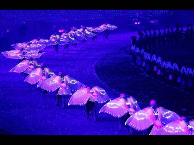 Performers wearing wings cycle in the arena during the opening ceremony of the London 2012 Olympic Games at the Olympic Stadium. Reuters/Mike Blake