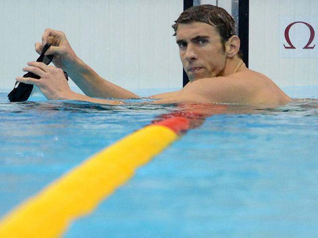 US-swimmer-Michael-Phelps-looks-on-after-competing-in-the-men-s-400m-individual-medley-heats-swimming-event-at-the-London-2012-Olympic-Games-in-London-AFP-Martin-Bureau