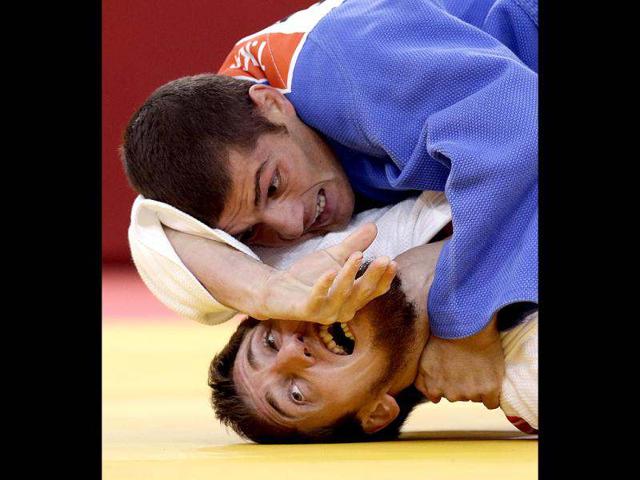 Tarlan Karimov of Azerbaijan (in blue) competes against Musa Mogushkov of Russia during the men's -66kg judo competition at the 2012 Summer Olympics, in London. (AP Photo)