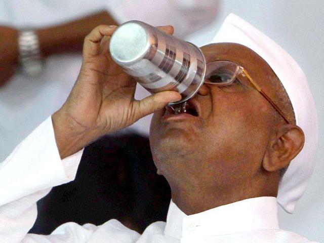 Hazare drinks a glass of water on the first day of his hunger-strike. PTI/Shahbaz Khan