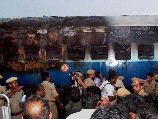 Police personnel near the coach of the Chennai-bound Tamil Nadu Express which caught fire near Nellore after a suspected short circuit. PTI Photo