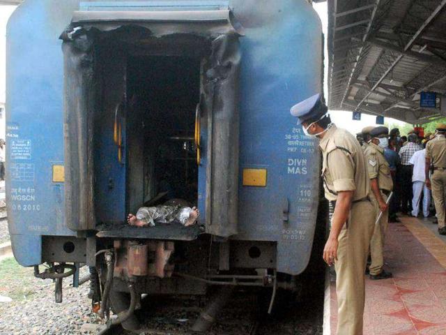 The body of a passenger is seen at the rear passageway of a gutted train carriage, which caught fire from an electrical short circuit killing at least 32, in Nellore. AFP photo