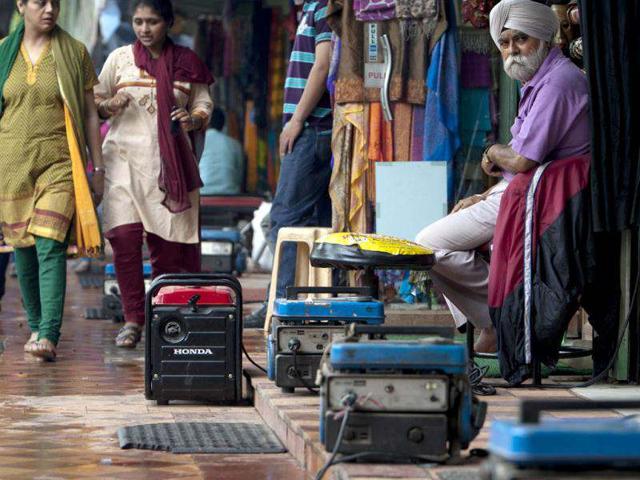 Portable power generators provide electrical power to souvenir shops along Janpath Market, during a power outtage in New Delhi. (AFP Photo)