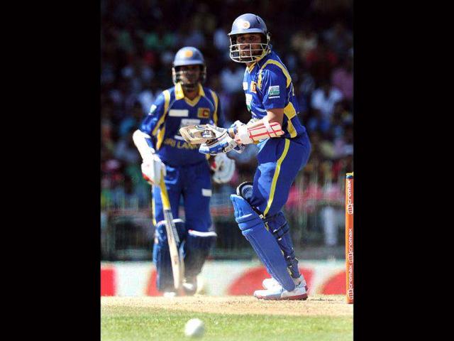 Sri Lankan cricketer Tillakaratne Dilshan (R) looks back after hitting a ball to the boundary during the fourth one day international (ODI) match between Sri Lanka and India at the R Premadasa Cricket Stadium in Colombo. AFP Photo/Lakruwan Wanniarachchi