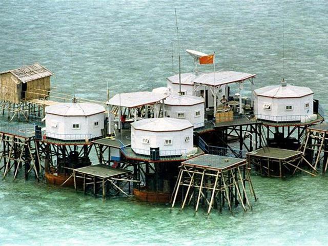 A Chinese flag and a satellite dish are prominently displayed in a structure built by China in one of the islands in the Spratlys, in the South China Sea. Reuters photo