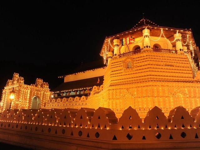Sri Lankan Buddhist Temple of the Tooth lit up for the Esala Perahera festival, in the ancient hill capital of Kandy, some 116 kms from Colombo. AFP Photo/Ishara S.Kodikara