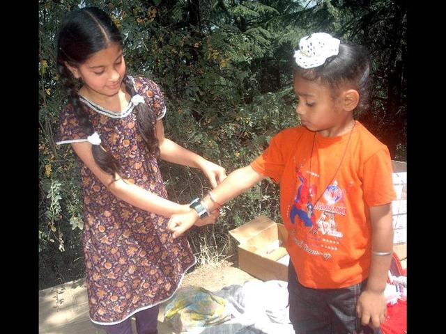 A girl ties rakhi on her brother's wrist on the occasion of Raksha Bandhan outside the Shiva temple Shankaracharya in Srinagar. Agency