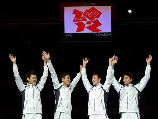 South Korea's team celebrate winning gold on the podium of the men's sabre team as part of the fencing event of London 2012 Olympic games, at the ExCel centre in London. AFP Photo/Toshifumi Kitamura