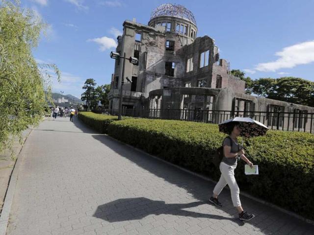 A woman walks past Atomic Bomb Dome in Hiroshima, western Japan. AP/Itsuo Inouye