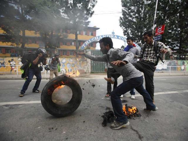 Activists of the Communist Party of Nepal Unified Marxist Leninist (CPN-UML) affiliated with Youth Association Nepal rolls a burning wheel during their general strike demanding the immediate resignation of Prime Minister Baburam Bhattarai in Kathmandu. Reuters/Navesh Chitrakar