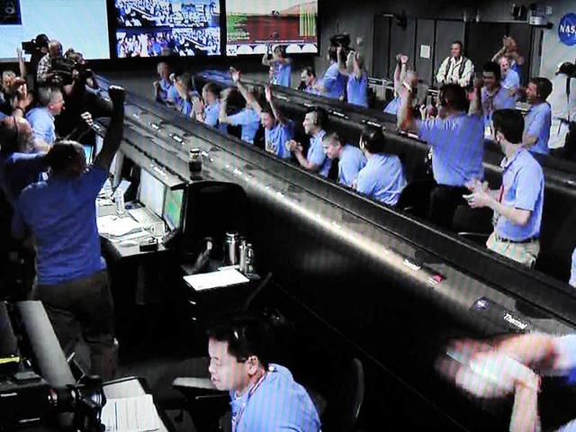 This screen grab from Nasa Television shows the Mars Science Laboratory (MSL) Curiosity Rover Mission Control room erupting in celebration as an image transmitted from the Curiosity Rover confirms a successful landing on the Red Planet at the Jet Propulsion Laboratory in Pasadena, California. AFP/Nasa Television