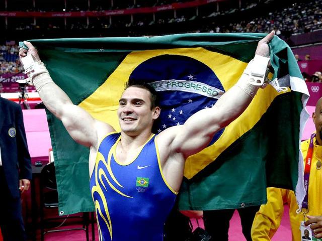 Brazil's gymnast Arthur Nabarrete Zanetti celebrates winning gold in the men's rings final of the artistic gymnastics event of the London Olympic Games at the 02 North Greenwich Arena in London. Brazil's Arthur Nabarrete Zanetti won gold, while China's Chen Yibing took silver and Italy's Matteo Morandi got bronze. (AFP photo/Thomas Coex)