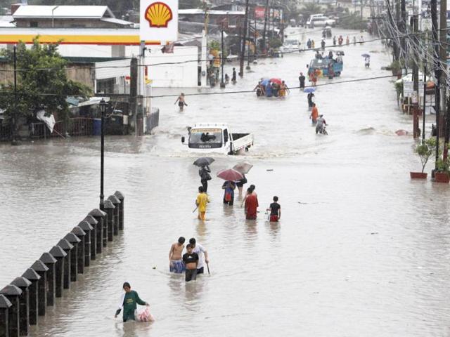Residents wade on a flooded street in Las Pinas, Metro Manila. Monsoon rains swamped the Philippine capital and nearby provinces. Reuters/Erik De Castro