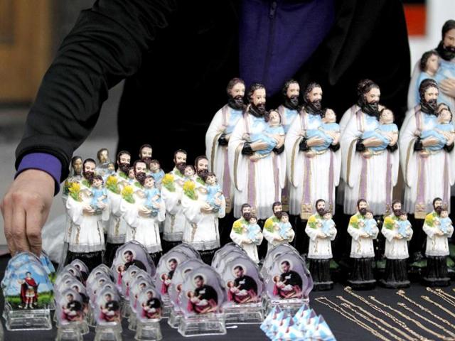 Figurines of San Cayetano (Saint Cajetan), the patron saint of labour and bread, are displayed for sale to faitfhul during the annual gathering and pilgrimage to the church dedicated to the saint in Buenos Aires. Reuters/Enrique Marcarian