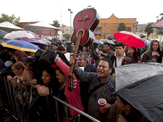 People sing and cheer during a homage to famed Mexican singer Chavela Vargas at the traditional Mariachi Garibaldi Plaza in Mexico City. AP Photo/Eduardo Verdugo