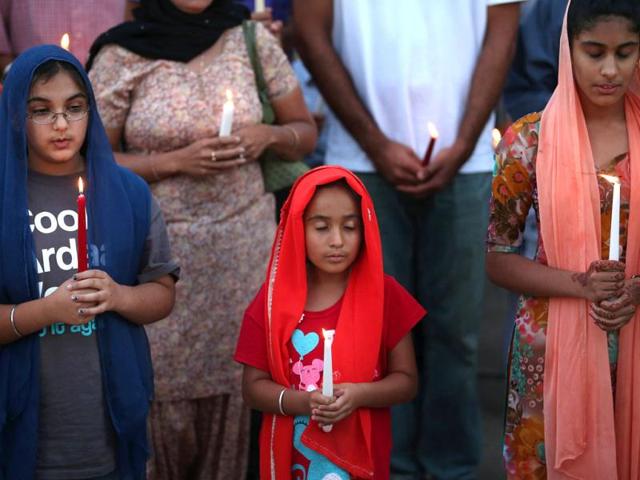 Guests attend an interdenominational candlelight vigil at the Illinois Sikh Community Center in Wheaton, Illinois. AFP/Scott Olson
