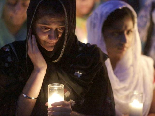 Mourners cry during a candlelight vigil at the Sikh Temple in Brookfield, Wisconsin. Reuters/John Gress
