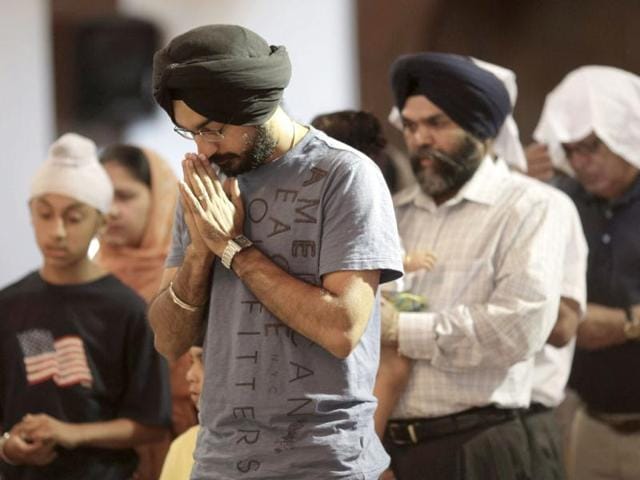 Mourners attend a prayer service at the Sikh Temple in Brookfield, Wisconsin. The gunman who killed six worshipers at a Sikh temple in Wisconsin was identified as a 40-year-old US Army veteran and authorities said they were investigating possible links to white supremacist groups and his membership in skinhead rock bands. Reuters/John Gress