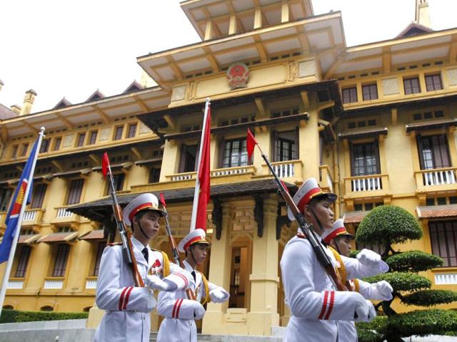 Honour guards march past the Association of Southeast Asian Nations (ASEAN) flag and Vietnamese flag after a flag raising ceremony to mark the 45th anniversary of the regional group at Vietnam's Ministry of Foreign Affairs in Hanoi. (Reuters)