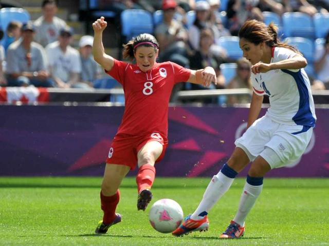 Canada's midfielder Diana Matheson (L) fights for the ball with France's Louisa Necib during the women's football match for bronze of the London 2012 Olympic Games at the City of Coventry stadium in Coventry. AFP Photo/Paul Ellis