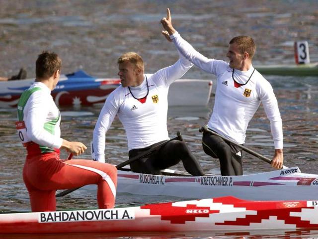 Germany's Peter Kretschmer (R) and Kurt Kuschela (C) celebrate winning their men's canoe double (C2) 1000m finals. Reuters/Darren Whiteside
