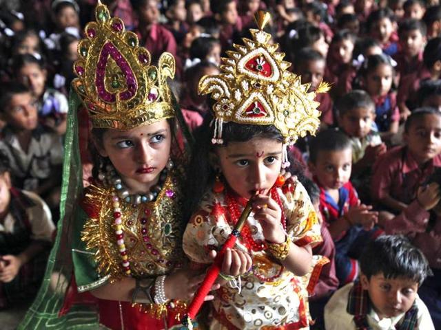 School children dressed as Lord Krishna (R) and Goddess Radha, take part during celebrations on the eve of the Janmashtami in Jammu. Reuters/Mukesh Gupta