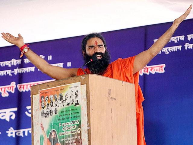 Yoga guru Baba Ramdev addresses his supporters on the issues of black money and corruption at Ramlila Ground in New Delhi. (PTI Photo/Kamal Singh)