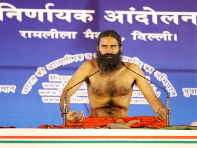 Yoga Guru Baba Ramdev performs Yoga during the agitation against black money and Corruption at Ramleela Ground in New Delhi. (HT Photo/Arvind Yadav)