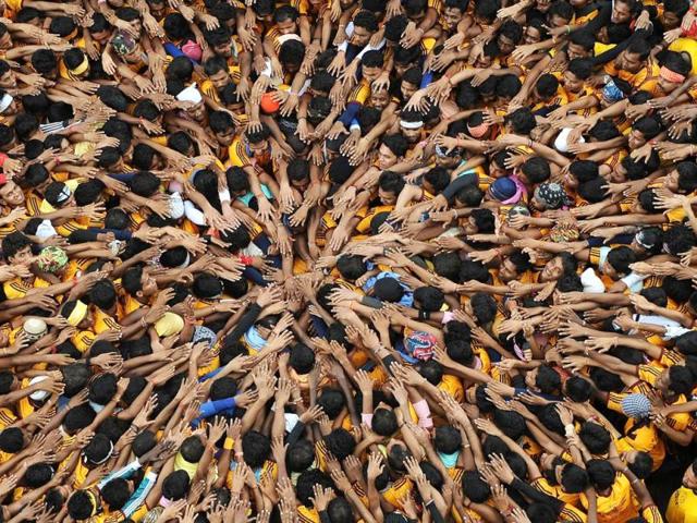 Indian Hindu devotees form a human pyramid to break the dahi-handi suspended in the air during celebrations of Janmashtami, which marks the birth of Hindu God Lord Krishna. (AFP /Punit Paranjpe)