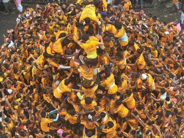 Indian Hindu devotees form a human pyramid to break the dahi-handi suspended in the air during celebrations of Janmashtami, which marks the birth of Hindu God Lord Krishna. (AFP /Punit Paranjpe)