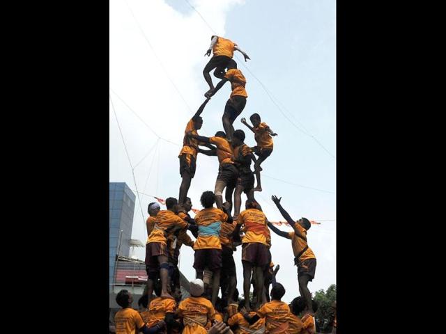 Indian Hindu devotees form a human pyramid to break the dahi-handi suspended in the air during celebrations of Janmashtami, which marks the birth of Hindu God Lord Krishna. (AFP /Punit Paranjpe)
