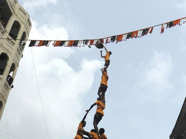 Indian Hindu devotees form a human pyramid to break the dahi-handi suspended in the air during celebrations of Janmashtami, which marks the birth of Hindu God Lord Krishna. (AFP /Punit Paranjpe)