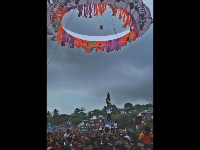 Youths formed a human pyramid to break the Dahi Handi, an earthen pot containing yogurt, during Janmashtami celebrations in Mumbai.(UNI)
