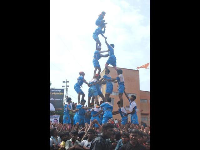 Youths formed a human pyramid to break the Dahi Handi, an earthen pot containing yogurt, during Janmashtami celebrations in Mumbai.(UNI)